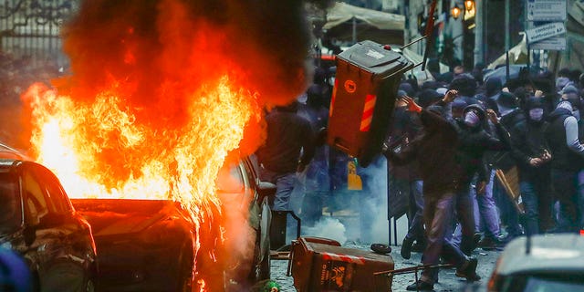 Supporters of the Eitracht Frankfurt soccer team clash with police Wednesday, March 15, 2023 in Naples, southern Italy, where their team is about to play a Champions League, round of 16, second leg soccer match against Naples.