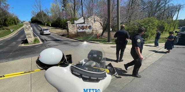 Metro Nashville Police Department officers walk outside of Covenant School, Covenant Presbyterian Church, in Nashville, Tennessee, Monday, March 27, 2023.