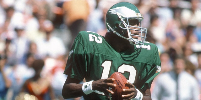 Randall Cunningham, #12 of the Philadelphia Eagles, drops back to pass against the Washington Redskins during an NFL Football game Sept. 7, 1986 at RFK Stadium in Washington, D.C. Cunningham played for the Eagles from 1985-1995.