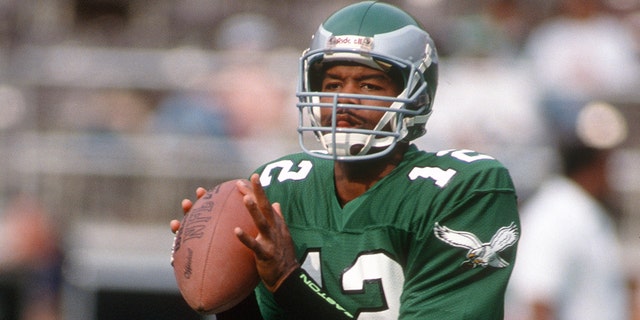 Randall Cunningham, #12 of the Philadelphia Eagles, looks to pass during an NFL Football game circa 1990 at Veterans Stadium in Philadelphia. Cunningham played for the Eagles from 1985-1995.