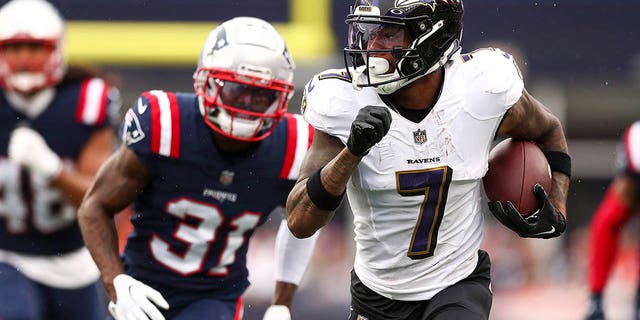 Wide receiver Rashod Bateman, #7 of the Baltimore Ravens, runs upfield while cornerback Jonathan Jones, #31 of the New England Patriots, pursues during the fourth quarter at Gillette Stadium on Sept. 25, 2022 in Foxborough, Massachusetts.