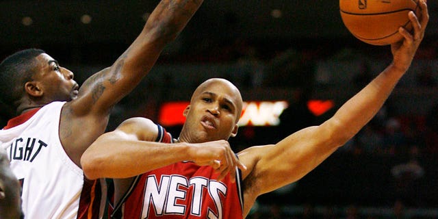 Heat's Dorell Wright attempts to block New Jersey Nets' Richard Jefferson in Miami on Dec. 20, 2007.