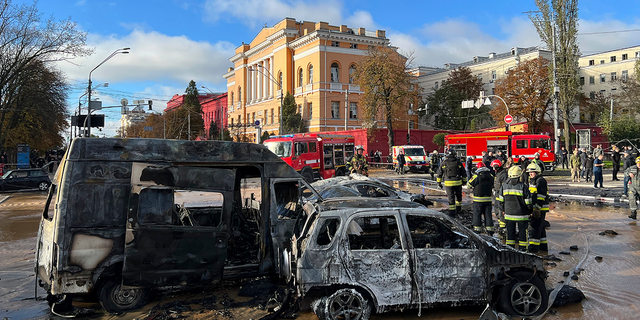 Rescue workers survey the scene of a Russian attack on Kyiv, Ukraine.