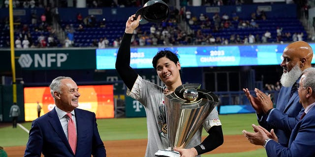 Shohei Ohtani receives the World Baseball Classic trophy on behalf of his team, Tuesday, March 21, 2023, in Miami.