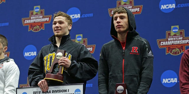 Spencer Lee of the Iowa Hawkeyes and Nick Suriano of the Rutgers Scarlet Knights stand on the awards podium during session six of the NCAA.