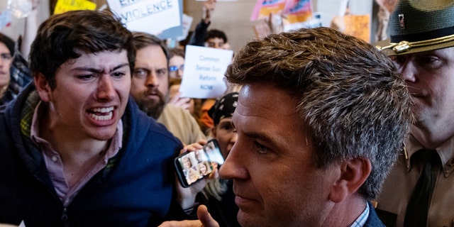 Protestors gather inside the Tennessee state Capitol for stricter gun laws and one protestor yells at a lawmaker as he pushes through the crowd on March 30, 2023. On March 27, a 28-year-old former student who attended Covenant School in Nashville, used a handgun and two AR-style weapons, killed three 9-year-old students and three adults before police came to the school and killed the shooter. 