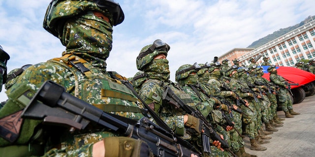 Soldiers stand guard after a preparedness enhancement drill simulating the defense against Beijing's military intrusions, ahead of the Lunar New Year in Kaohsiung City, Taiwan on Wednesday.