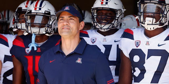 Former NFL linebacker and University of Arizona alum Tedy Bruschi stands with players before taking the field as a coach in the Arizona spring game at Arizona Stadium April 24, 2021, in Tucson, Ariz.