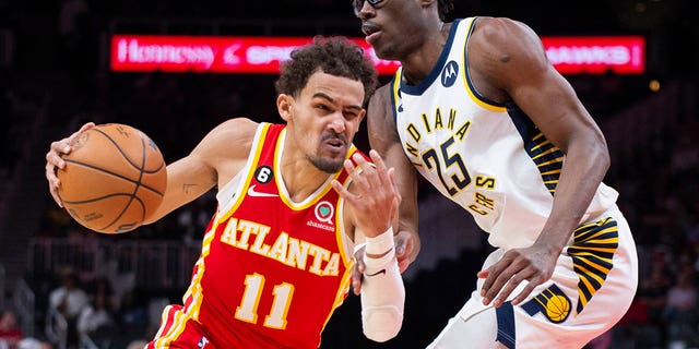 Hawks guard Trae Young drives past Indiana Pacers forward Jalen Smith, Saturday, March 25, 2023, in Atlanta.