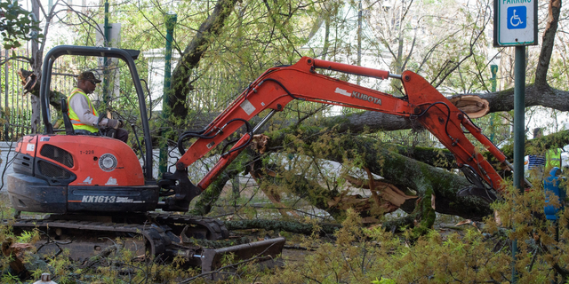 City of Jackson employees clear a tree fallen from the property at the governor s mansion in Jackson, Miss., March 3, 2023. The tree, toppled due to heavy wind as severe weather passed through the state Friday, blocked Congress Street and broke a window in a building across from the mansion. High winds left thousands of Mississippians without power.