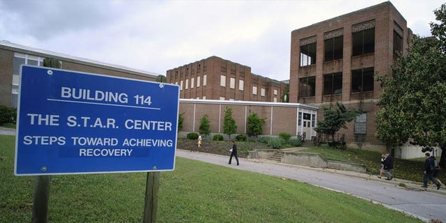 Visitors walk toward a building at Central State Hospital in Virginia on May 17, 2018. Seven deputies were charged with second-degree murder after a Black man died at the Central State Hospital. 