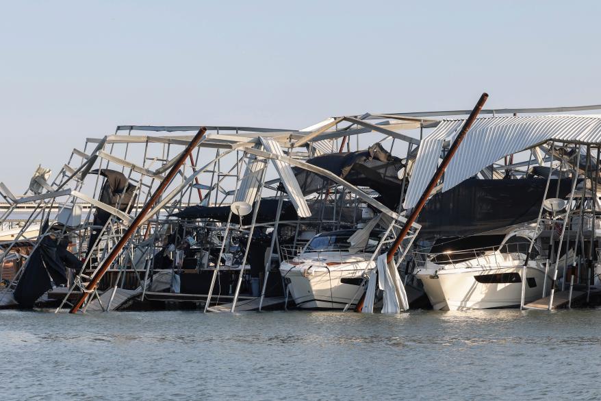 Two boats are damaged from a docking structure in Lake Lewisville marina in Texas on March 3, 2023.