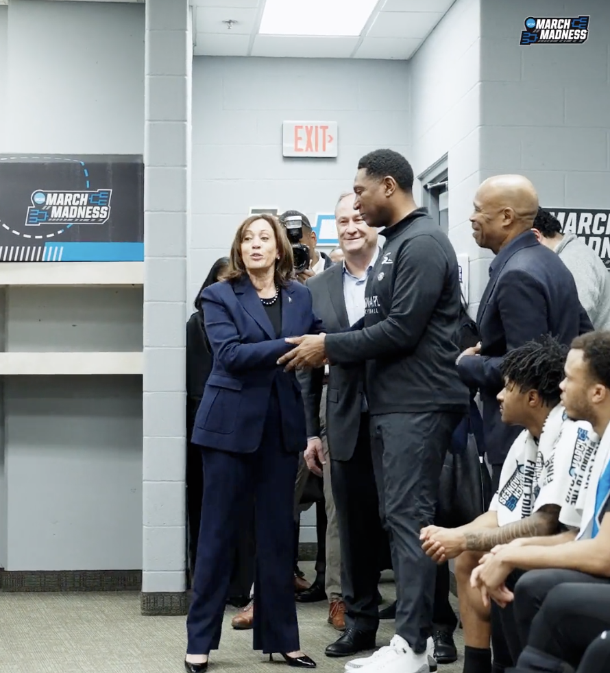 Vice President Kamala Harris shakes Howard Bison Men's Basketball coach Kenny Blakeney's hand during her speech to the team on March 16, 2023. 