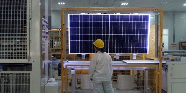 A worker quality checks a solar component in China. Chinese companies dominate the global solar panel supply chain.