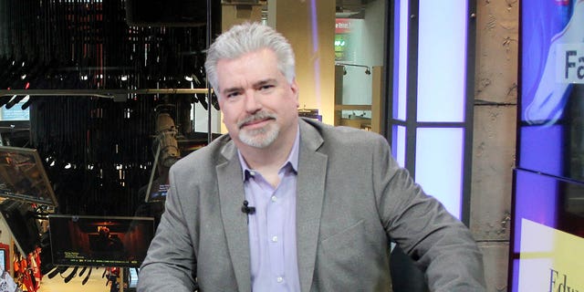 Don La Greca, host of the Edward Jones Face Time program, poses for photos in the studio at the NHL Powered by Reebok Store May 9, 2014, in New York City. 