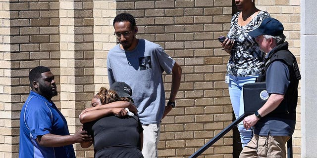 Parents comfort each other as they wait outside the Woodmont Baptist Church for students from Covenant School to arrive after a mass shooting at the school Monday, March 27, 2023, in Nashville, Tennessee.