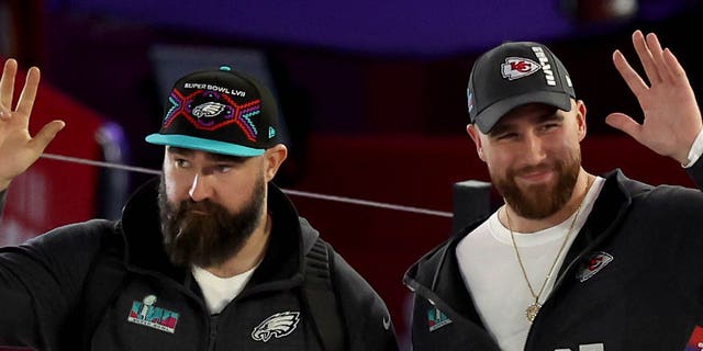 (L-R) Brothers Jason Kelce, #62 of the Philadelphia Eagles, and Travis Kelce, #87 of the Kansas City Chiefs, wave onstage during Super Bowl LVII Opening Night presented by Fast Twitch at Footprint Center on February 6, 2023, in Phoenix, Arizona.