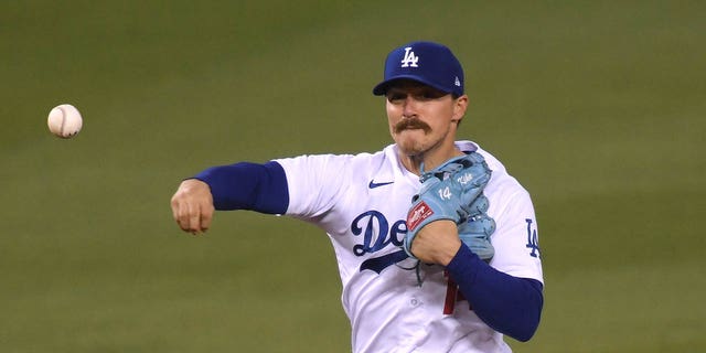 Enrique Hernandez of the Los Angeles Dodgers turns a double play during the eighth inning against the San Diego Padres at Dodger Stadium Aug. 12, 2020, in Los Angeles. 