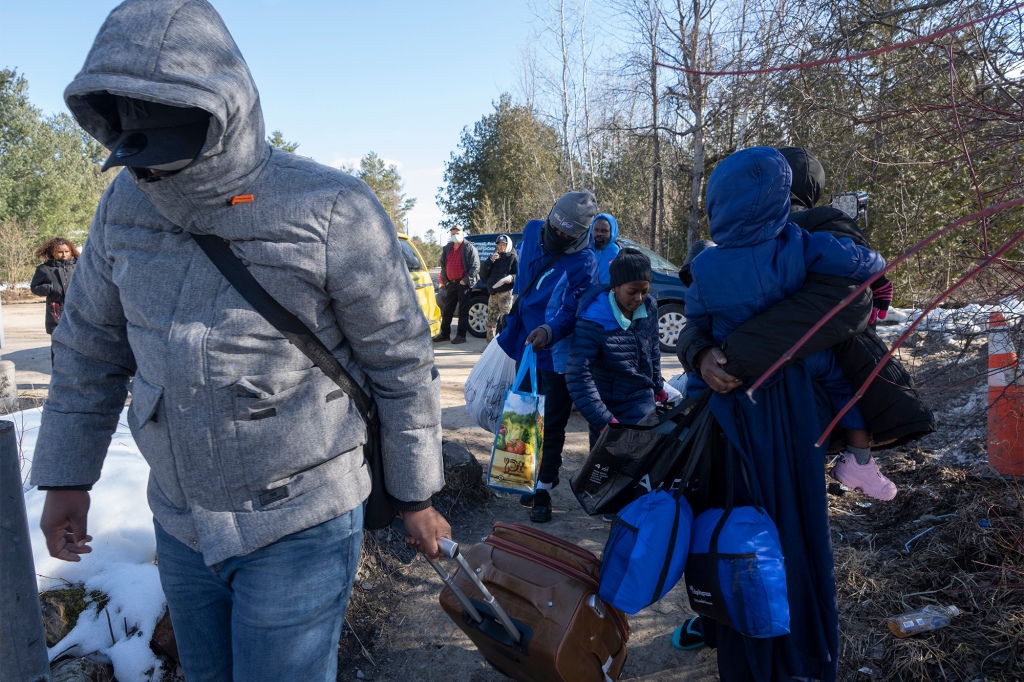 Asylum seekers cross the border at Roxham Road from New York into Canada.