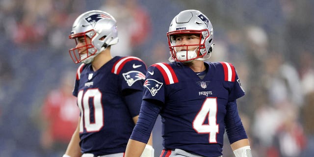 Mac Jones, left, and Bailey Zappe of the New England Patriots before the game against the Chicago Bears at Gillette Stadium on Oct. 24, 2022, in Foxborough.