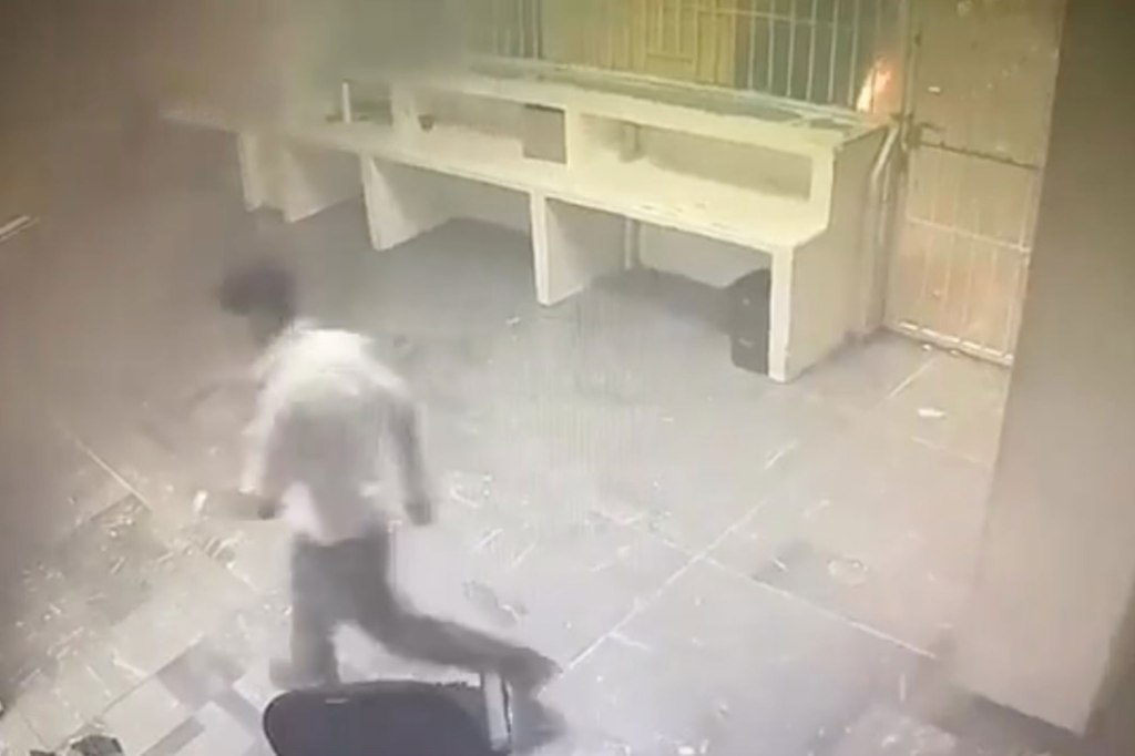 Footage shows guards walking away from the locked cell during the active fire of the Mexican immigration detention center in Ciudad Juarez, Mexico on March 27, 2023.
