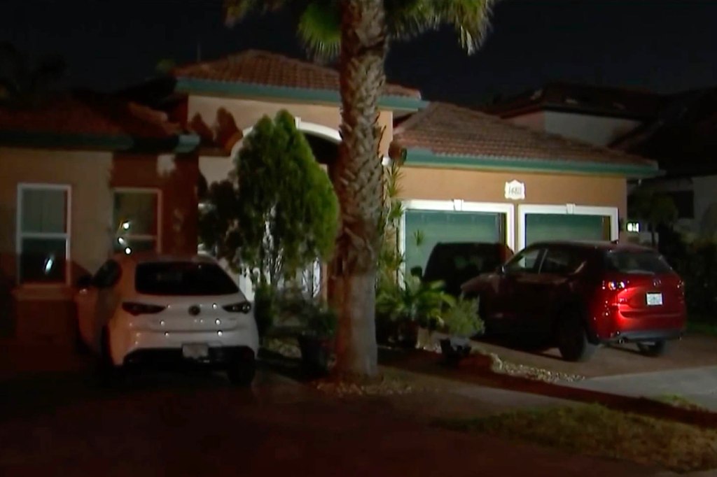 Police outside the Miami-Dade home where the murders occurred. 