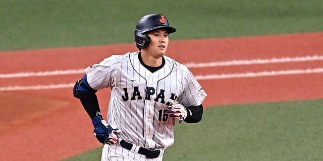 Designated hitter Shohei Ohtani, #16 of Japan, celebrates hitting a three-run home run in the fifth inning during the World Baseball Classic exhibition game between Japan and Hanshin Tigers at Kyocera Dome Osaka on March 6, 2023, in Osaka, Japan. 