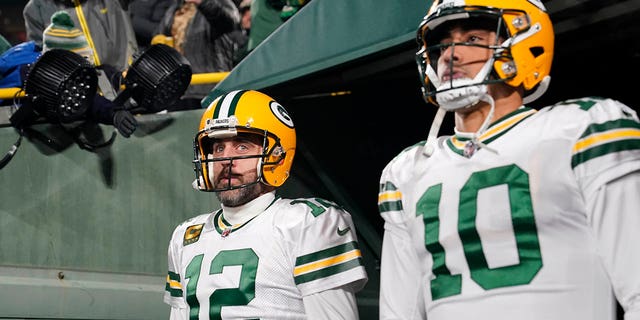 Aaron Rodgers, #12, and Jordan Love, #10, of the Green Bay Packers walk onto the field prior to the game against the Tennessee Titans at Lambeau Field on November 17, 2022, in Green Bay, Wisconsin. 