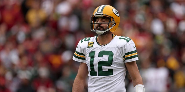 Aaron Rodgers #12 of the Green Bay Packers reacts after a play during the first quarter of the game against the Washington Commanders at FedExField on October 23, 2022 in Landover, Maryland.