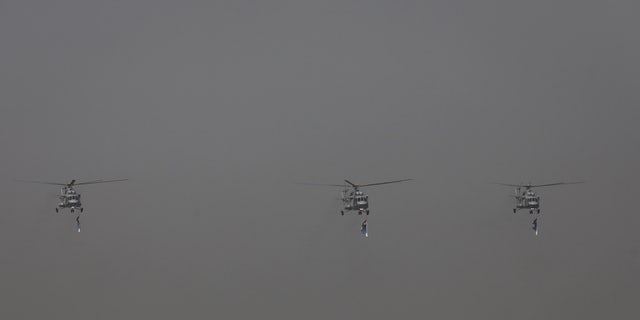 Indian Air Force's Mi-17 V5 perform in the air during the 89th Air Force Day parade, at Hindon Air Force Station in Ghaziabad, India, October 8, 2021. 