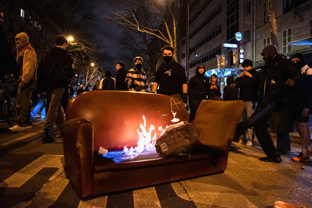 Protesters set a sofa on fire during riots over President Emmanuel Macron's law to raise the retirement age on March 22, 2023. 