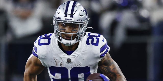 Tony Pollard #20 of the Dallas Cowboys carries the ball against the San Francisco 49ers during the second half in the NFC Wild Card Playoff game at AT&amp;T Stadium on January 16, 2022 in Arlington, Texas.