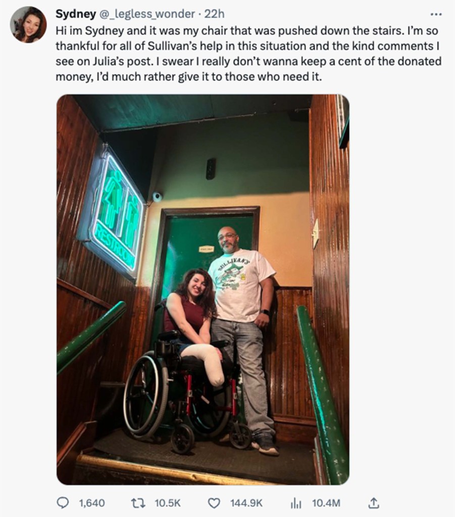 Woman in wheelchair posing with employee from Sullivan's Pub in Erie, PA