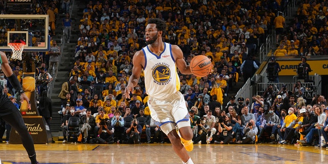 Andrew Wiggins of the Golden State Warriors dribbles the ball against the Boston Celtics during Game 5 of the 2022 NBA Finals June 13, 2022, at Chase Center in San Francisco. 