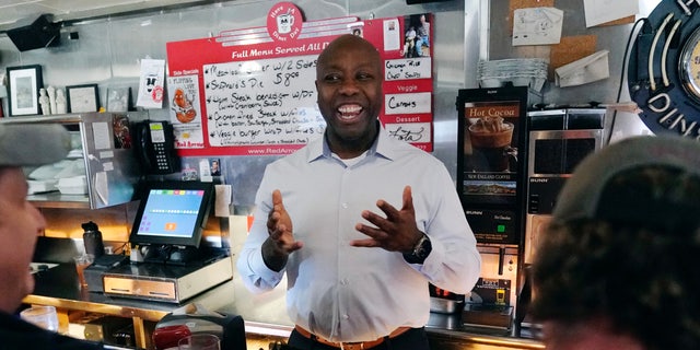 Sen. Tim Scott talks with diners during a visit to the Red Arrow Diner, Thursday, April 13, 2023, in Manchester, New Hampshire. Scott on Wednesday launched an exploratory committee for a 2024 GOP presidential bid, a step just shy of making his campaign official.