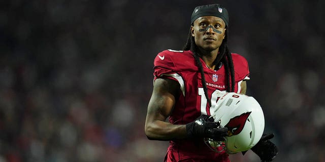 DeAndre Hopkins stands on the field before a game against the Patriots