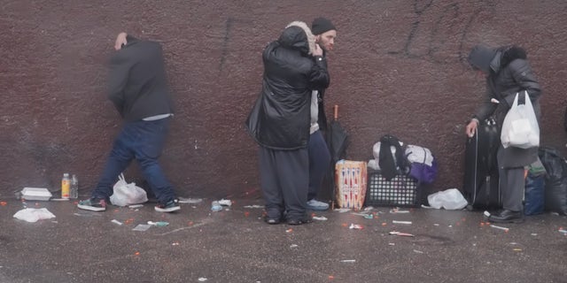 Philadelphia drug addicts line the sidewalk