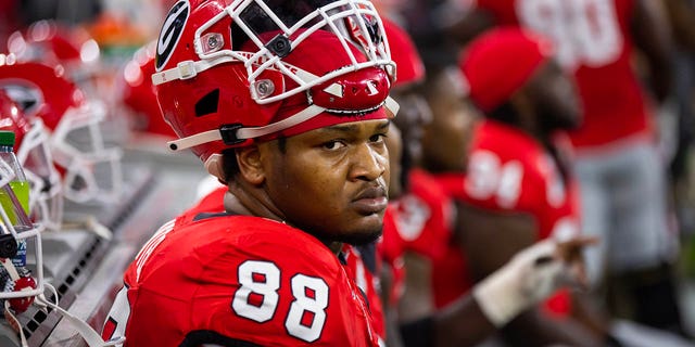 Jalen Carter with his helmet on top of his head