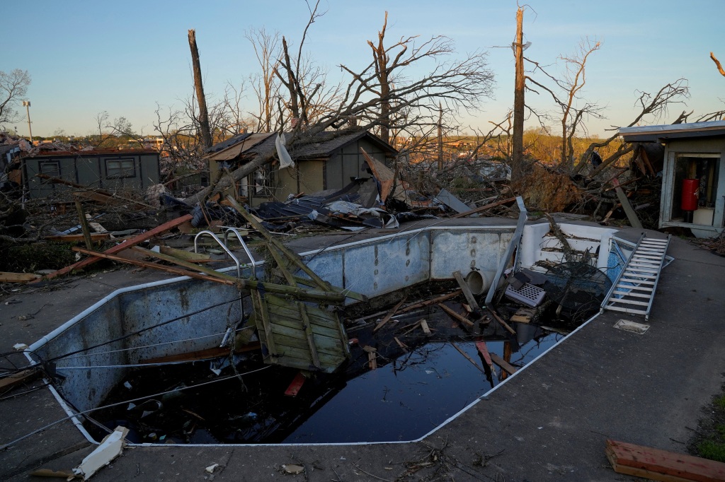 A swimming pool is seen filled with debris in the aftermath of a tornado, after a monster storm tore through the South and Midwest on Friday in Little Rock, Arkansas.