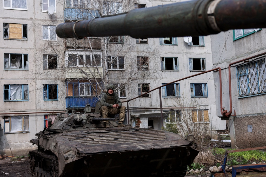 An Ukrainian serviceman sits atop an infantry fighting vehicle amid Russia's invasion of Ukraine, near the bombed-out eastern city of Bakhmut, in the eastern Donetsk region of Ukraine.