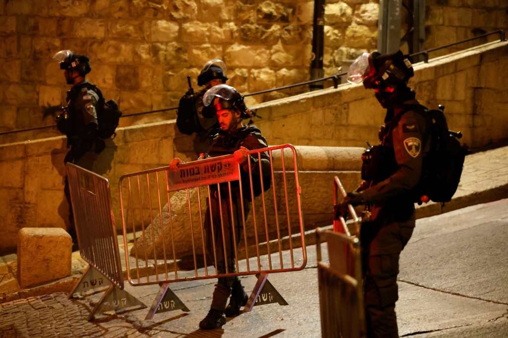 Israeli border policemen set up a fence near Al-Aqsa compound also known to Jews as the Temple Mount, while tension arises during clashes with Palestinians in Jerusalem's Old City, on April 5, 2023. 