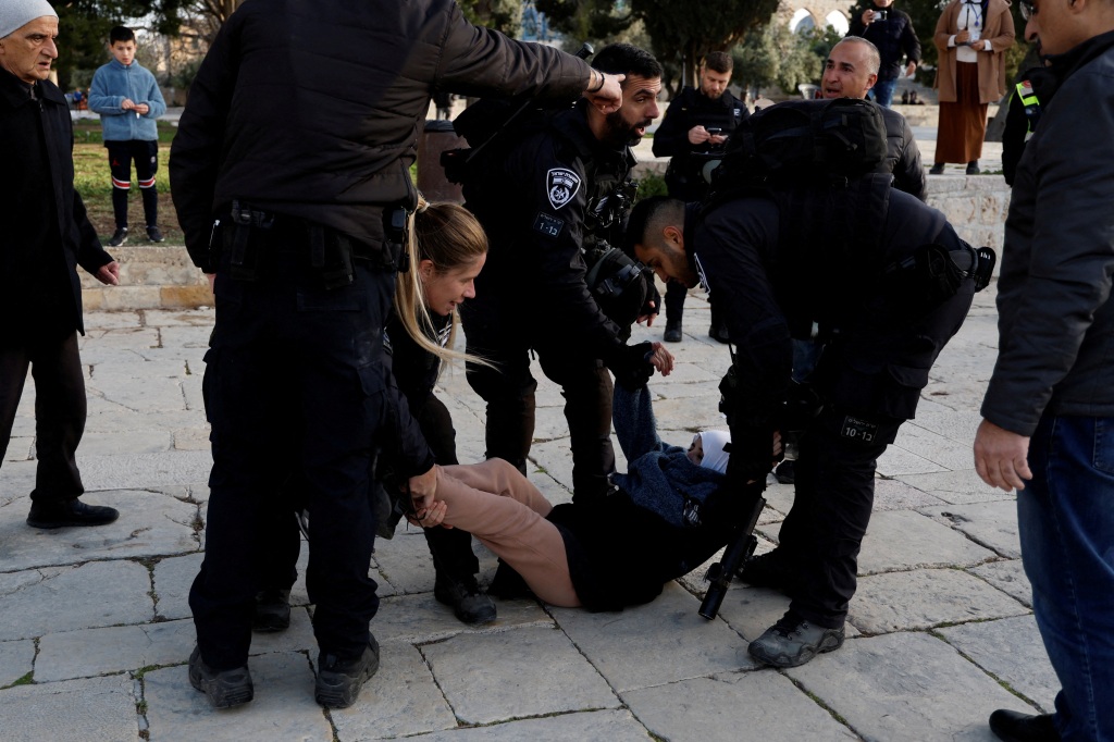 Israeli border police detain a Palestinian woman at the Al-Aqsa compound, also known to Jews as the Temple Mount, while tension arises during clashes with Palestinians in Jerusalem's Old City, April 5, 2023. 