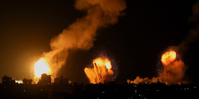 Smoke and flames rise during Israeli airstrikes in Khan Younis in the southern Gaza Strip, April 7, 2023.