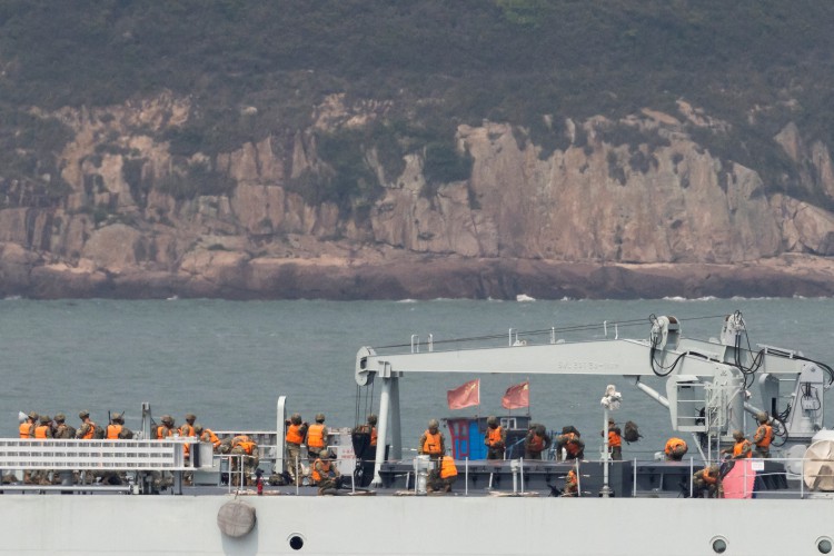 Soldiers stand on the deck of a Chinese warship as it sails during a military drill near Fuzhou, Fujian Province, near the Taiwan-controlled Matsu Islands in China on April 8, 2023.                                                                           