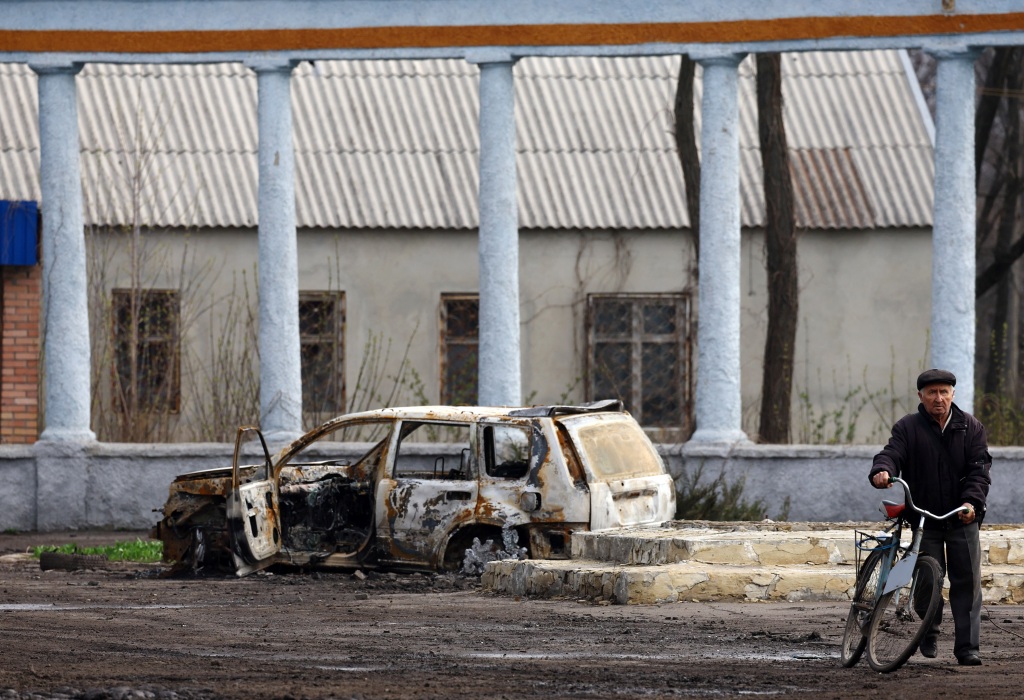 A villager is seen near a wracked car during heavy fighting at the front line of Bakhmut and Chasiv Yar, in Chasiv Yar, Ukraine on April 9, 2023.