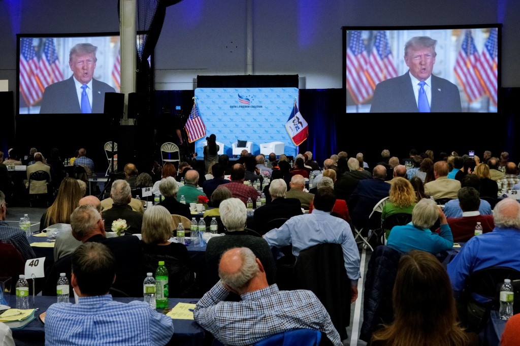 Former U.S. President Donald Trump is seen on-screen during the Iowa Faith & Freedom Coalition Spring Kick-off.