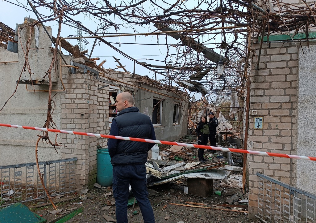 Police officers stand next to a residential house damaged by a Russian missile strike, amid Russia's attack on Ukraine, in Mykolaiv, Ukraine on April 27, 2023. 