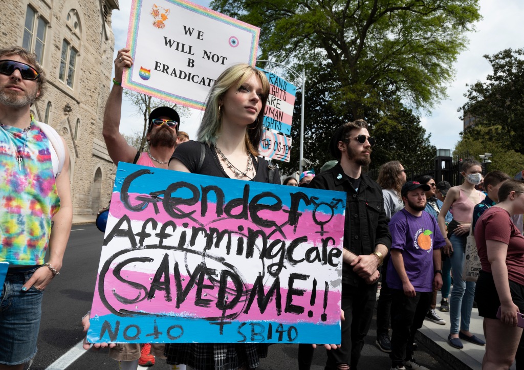 Transgender individuals, family members and advocates rally and march outside Georgia statehouse. 