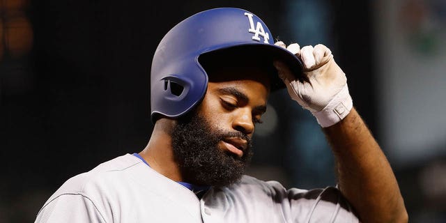 Andrew Toles of the Los Angeles Dodgers reacts after striking out against the Arizona Diamondbacks during the eighth inning of a game at Chase Field Aug. 16, 2016, in Phoenix, Ariz.  