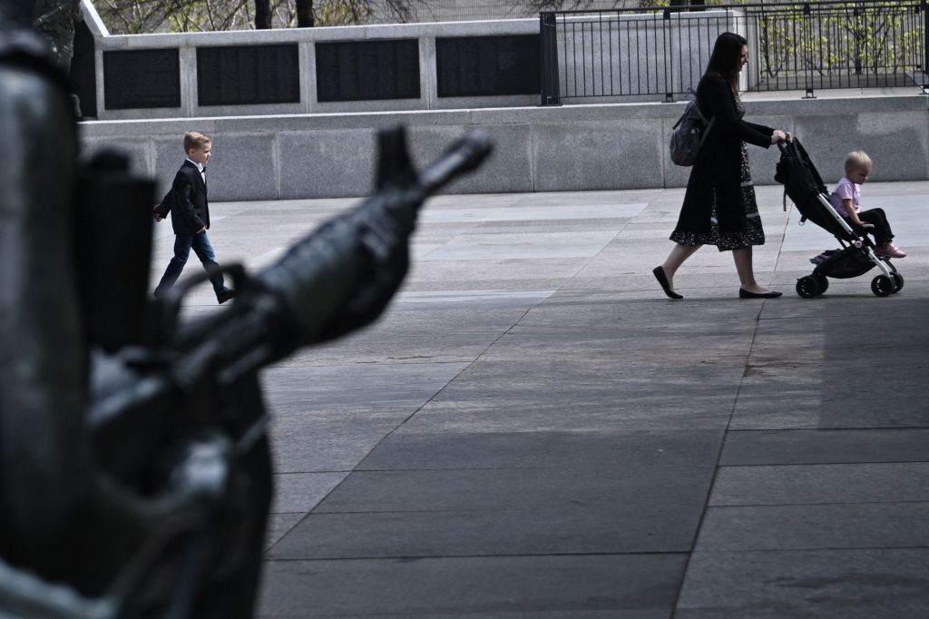 People walk past a statue near the Tennessee State Capitol in Nashville, Tennessee 